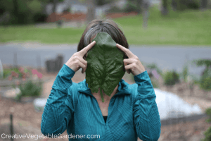 woman with huge spinach leaf