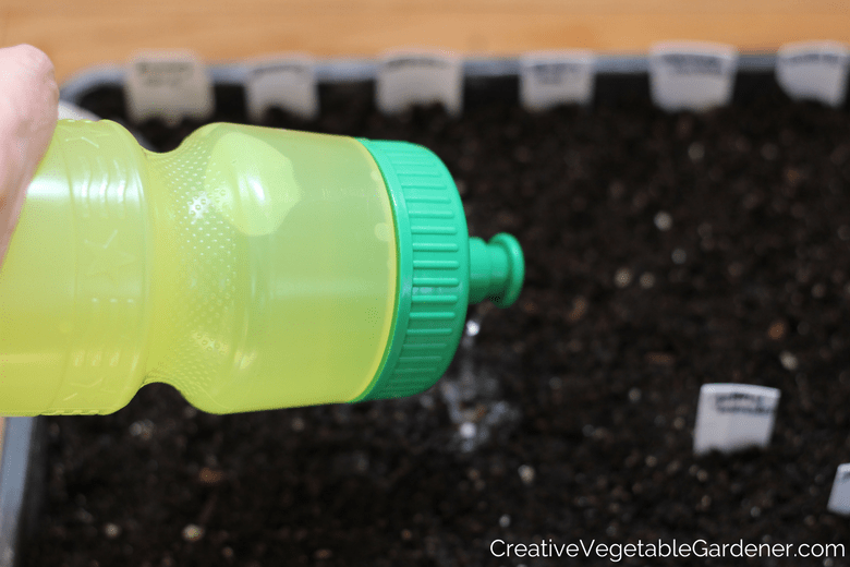 use a bike water bottle to water the plants on your grow light stand