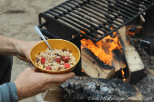 eating oatmeal by the fire healthy camping meals